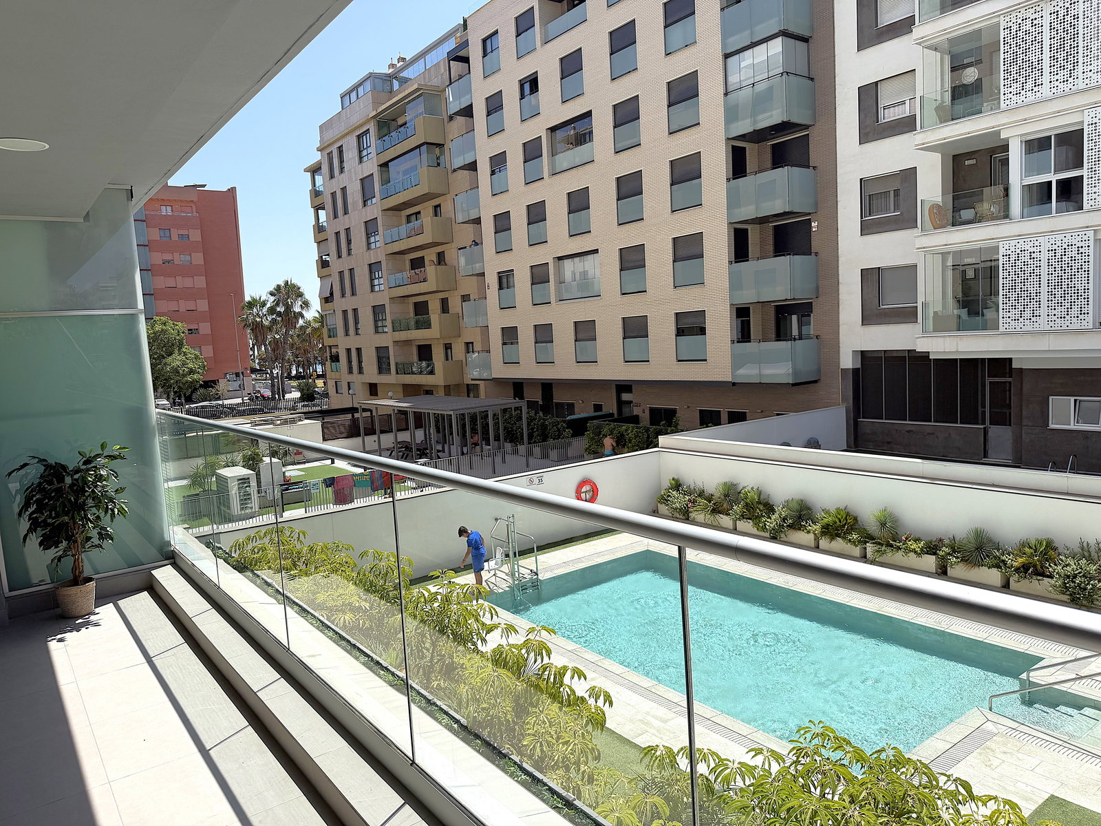 Relax on the private terrace overlooking the sparkling communal pool and modern courtyard.