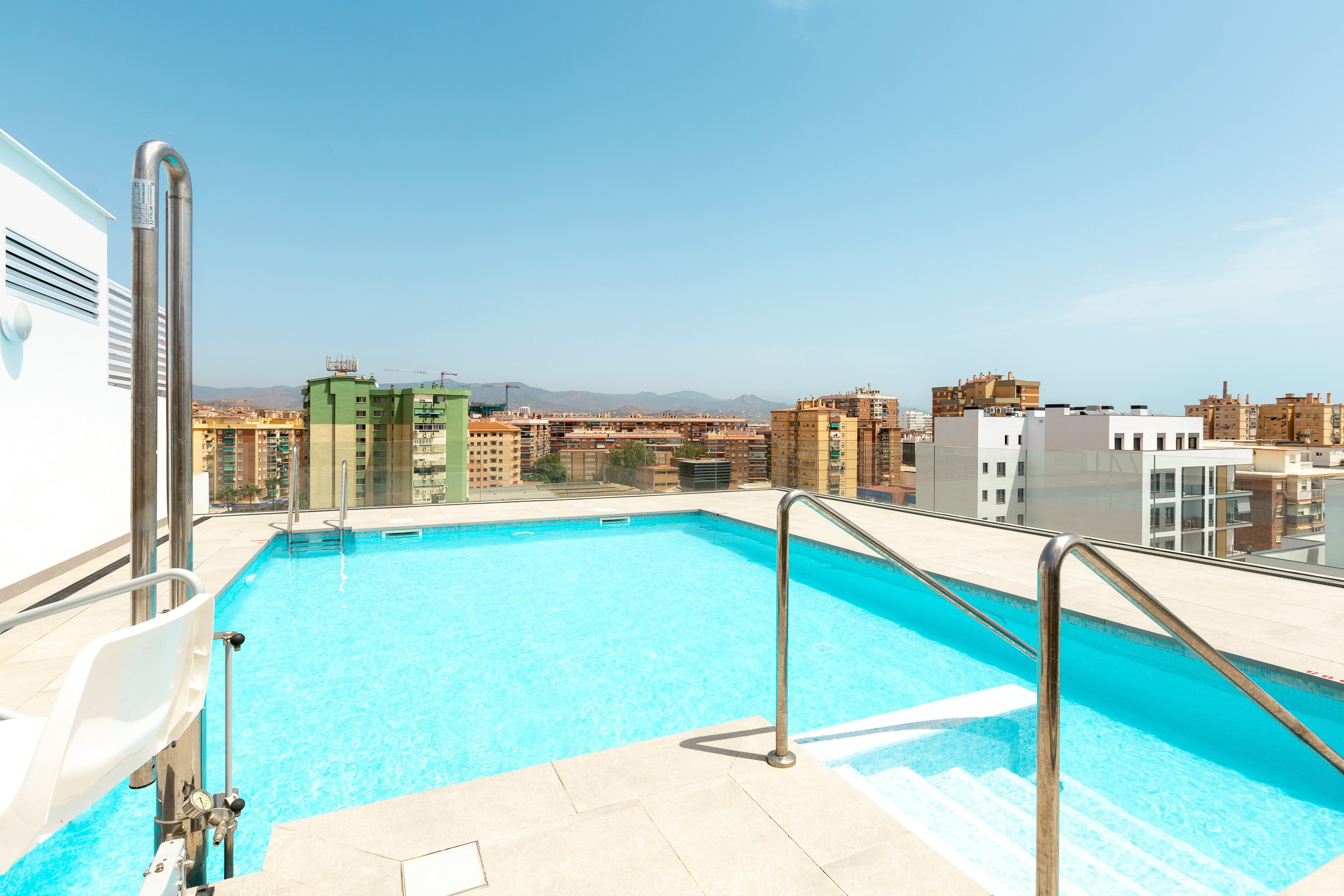 Pool with city and mountain views