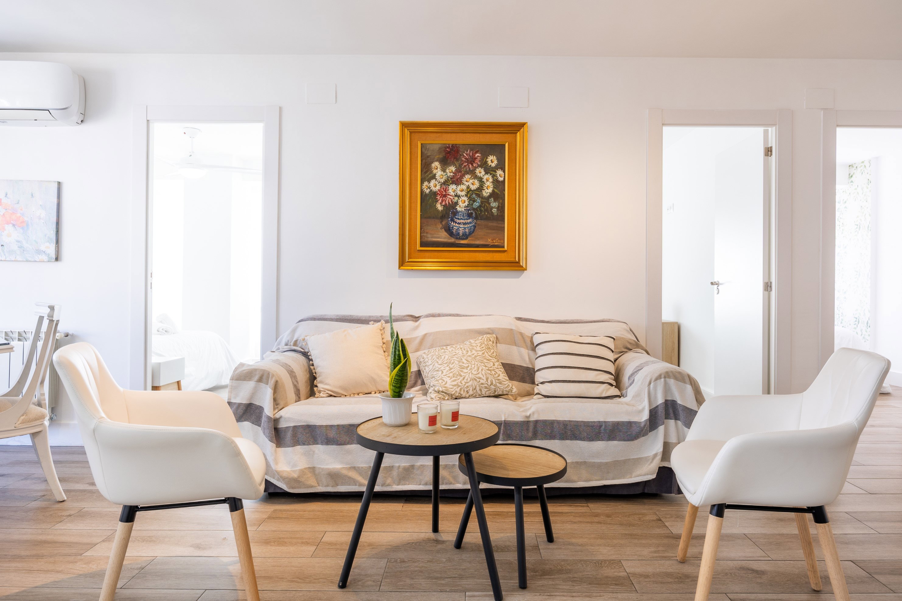 Unwind in this bright, air-conditioned living area with comfortable seating and charming framed artwork.
