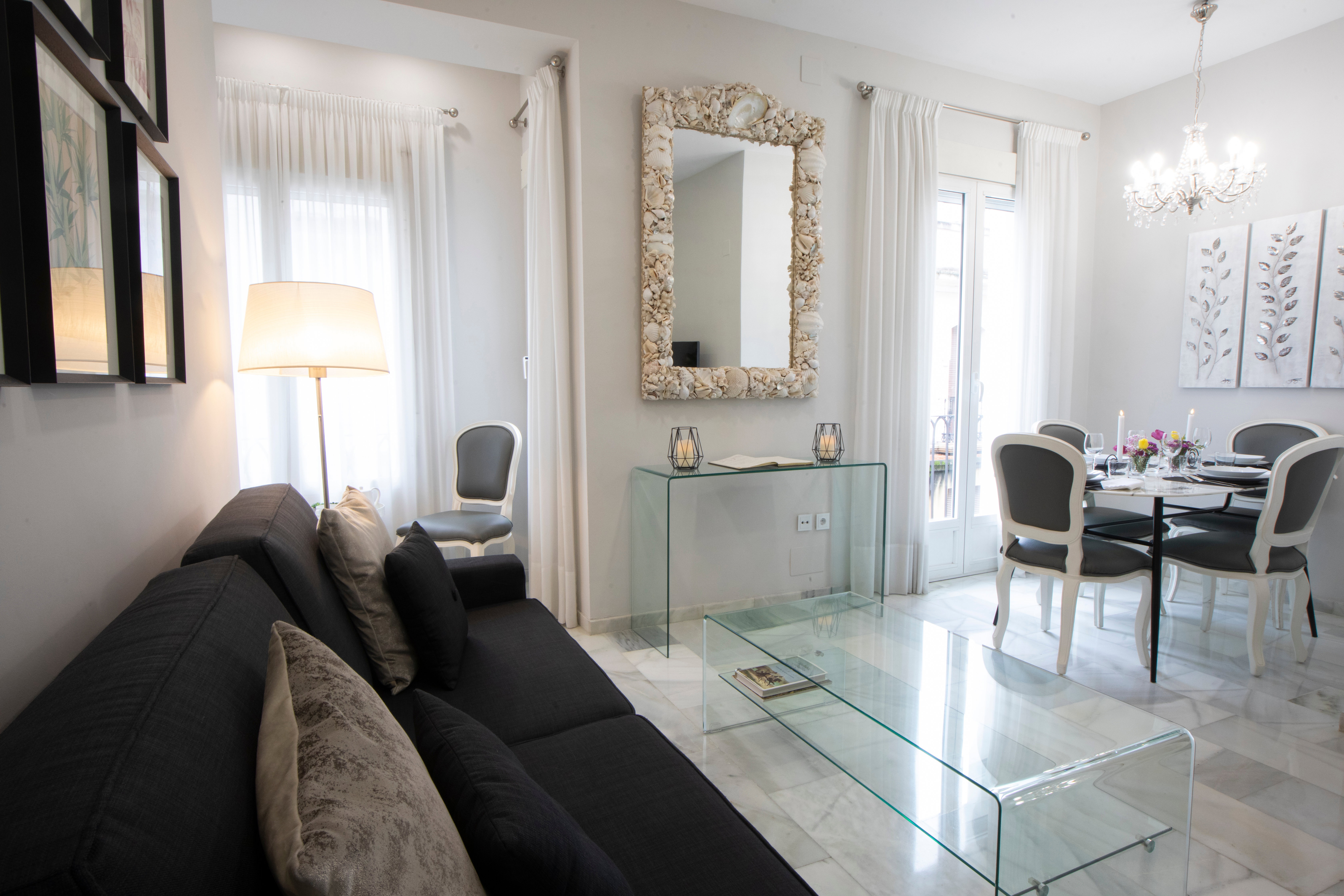 The sofa, situated at the heart of the home, is perfect for reading, as there is a lamp next to it that blends in with the rest of the décor
