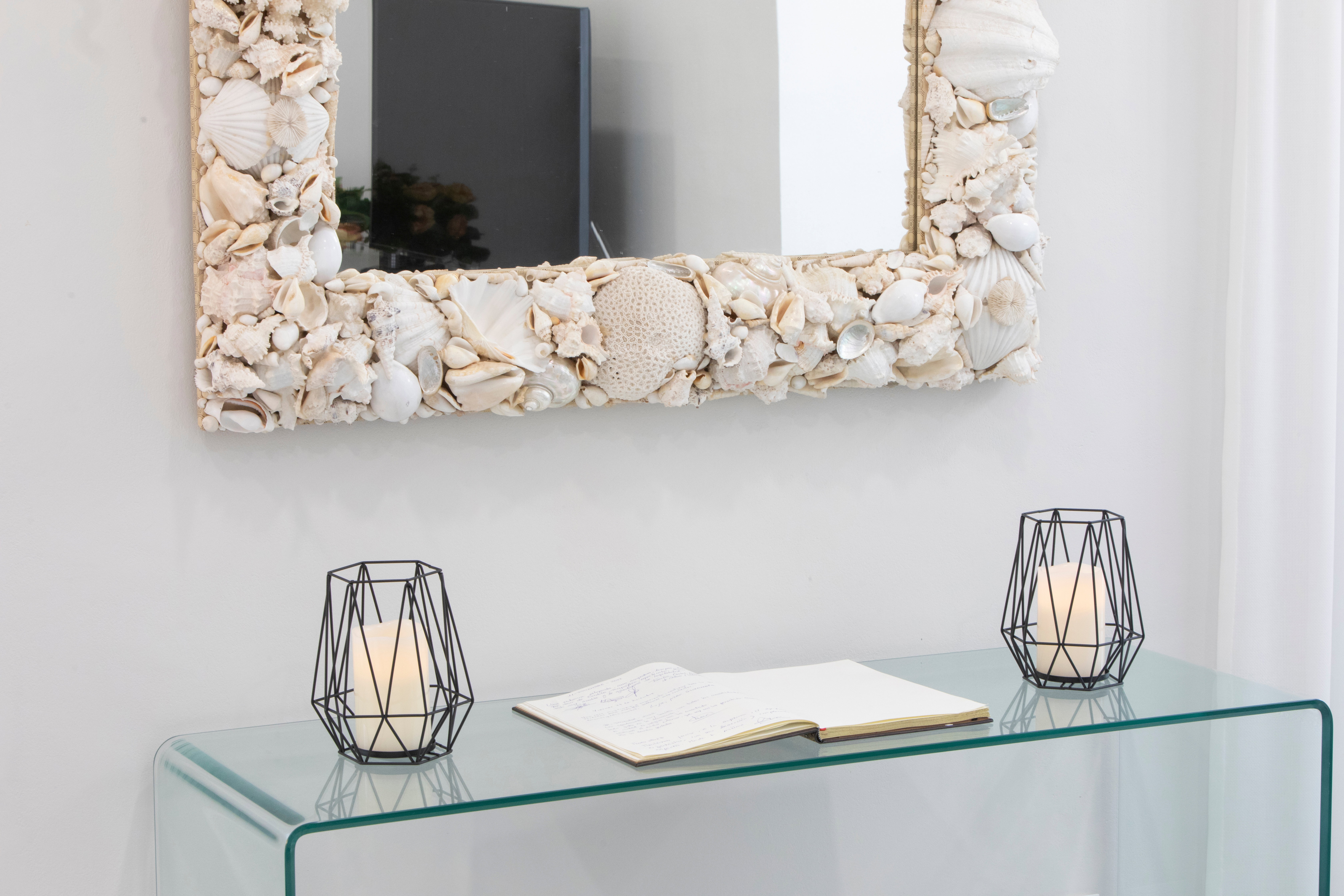 In the living room, there is also a fairly large mirror with a beautiful frame made of shells
