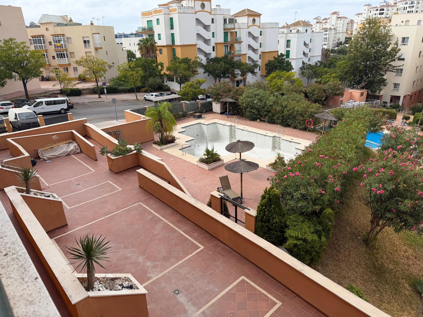 Enjoy views over the sunny terracotta terrace. Lush gardens and local architecture frame the setting.