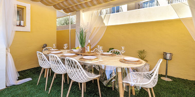 Dine al fresco on the private shaded patio. An elegant table for six creates a delightful setting for gatherings.